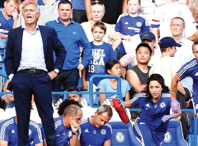 Chelsea doctor Eva Carneiro (right) leaves the bench to treat Eden Hazard during their match against Swansea. The incident led to Carneiro being criticised by Jose Mourinho (left) and later demoted. Pic/AFP