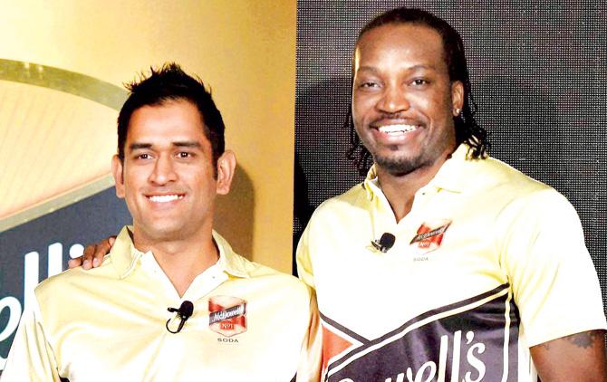 MS Dhoni with Chris Gayle during a promotional event in New Delhi yesterday. Pic/PTI 