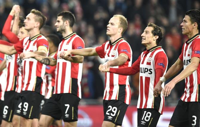 From R PSV Eindhoven-s Mexican defender Hector Moreno, PSV Eindhoven-s Mexican midfielder Andres Guardado and PSV Eindhoven-s Dutch defender Jorrit Hendrix celebrate with their teammates at the end of the UEFA Champions League football match PSV Eindhoven vs VfL wolfsburg at the Philips Stadion stadium in Eindhoven. Pic/AFP
