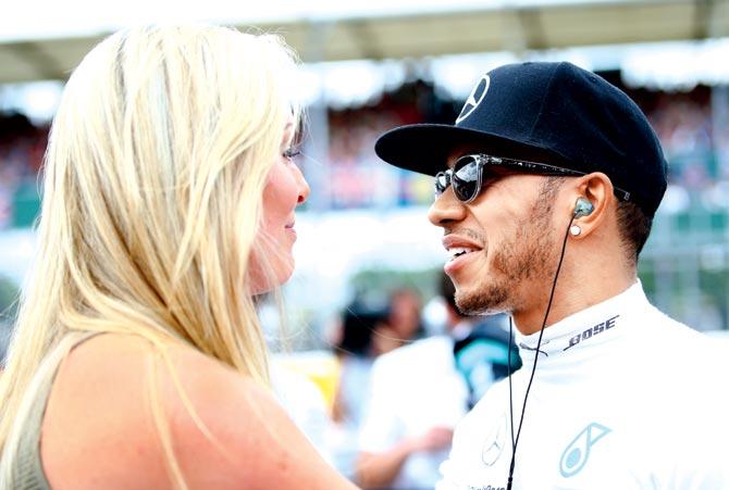 Lewis Hamilton speaks with Lindsey Vonn on the grid before the Silverstone Grand Prix in Northampton, England on July 5, 2015. Pic/Getty Images 