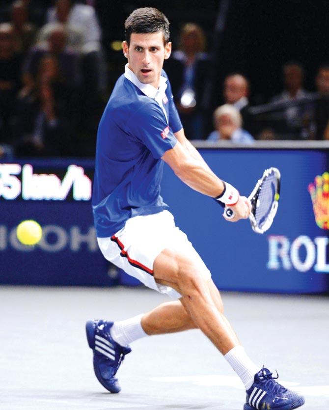 Novak Djokovic returns to Gilles Simon in Paris yesterday. Pic/AFP