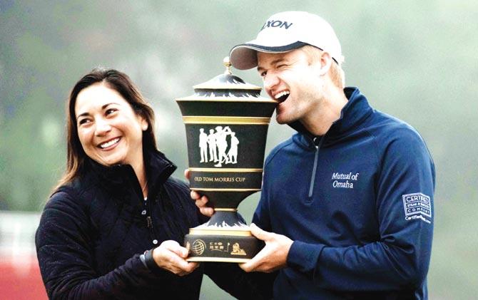 Scotsman Russell Knox and wife Andrea pose with his WGC-HSBC Champions winner