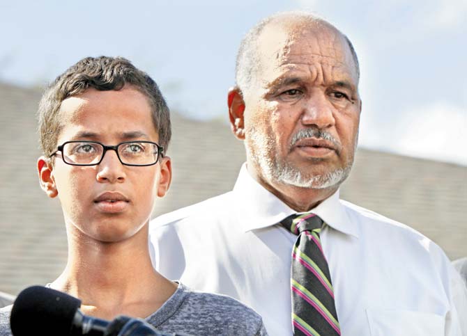 Ahmed with his father. Pic/AFP