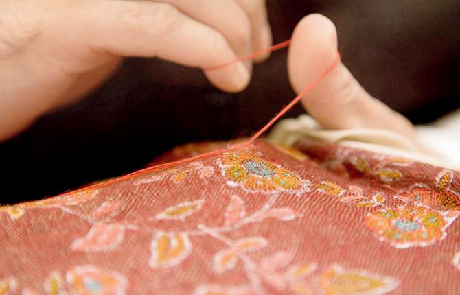 An embroiderer uses the Kanikar embroidery technique
