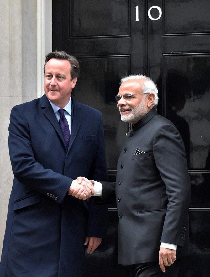 Prime Minister Narendra Modi and his UK counterpart David Cameron shake hands before a delegation level meeting at 10 Downing Street in London on Thursday