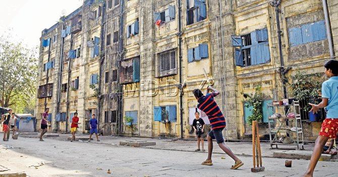 Children play cricket. This space and freedom may slip out of their hands once buildings come up 