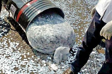 Drums carrying coins spill on to National Highway