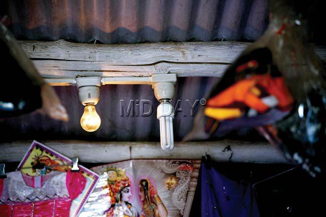 A lone bulb barely lights the readymade clothes shop. The village faces around 14 hours of load-shedding every day