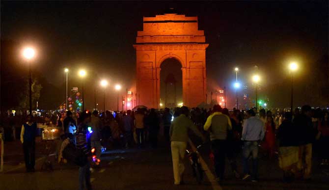 India Gate is illuminated in orange to raise awareness about ending violence against women in New Delhi on Wednesday