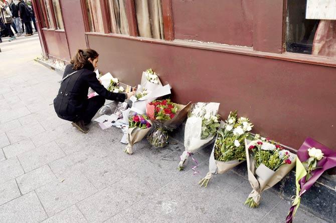 Flowers placed next to blood stains at the Bataclan Theatre