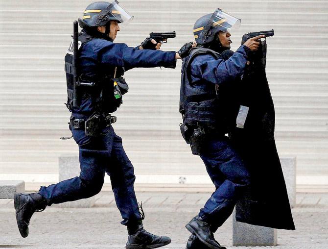 Police forces operate in Saint-Denis, a northern suburb of Paris, where the pre-dawn raids were held yesterday.
