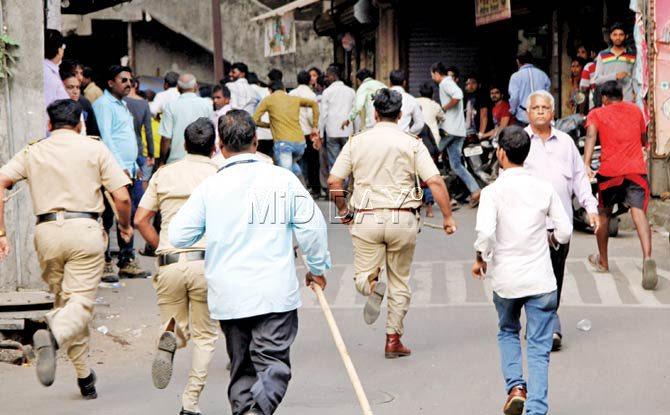 Cops rush to stop a brawl that broke out between Sena and BJP workers in Dombivli yesterday