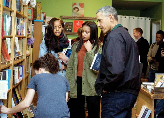 US President Barack Obama with Sasha and Malia at the Upshur Street Books store. Pic/AP