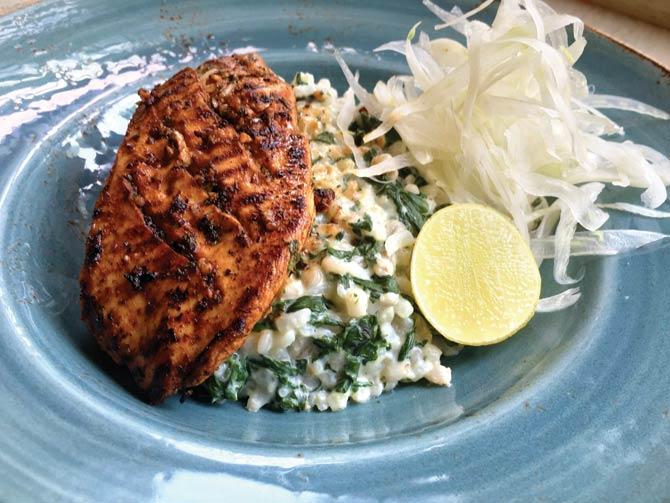 The diabetic-friendly Cajun Spiced Grilled Chicken served on a bed of barley, oats, spinach and sprout risotto with shaved fennel