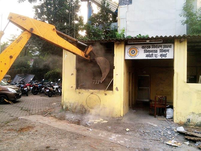 The traffic chowky being demolished. Traffic can be seen moving towards the road going to Andheri station. Pic courtesy/BMC