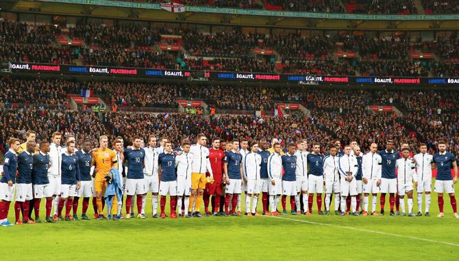 England and France players stand together for a solemn moment prior to their friendly at Wembley Stadium on Tuesday. PIC/Getty Images 