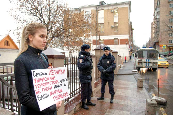 A woman holds a poster as she pickets the Turkish Embassy in Moscow, Russia. Pics/PTI