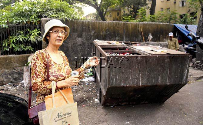 Zarine Bahamani, a Rustom Baug resident, points to the open garbage bin. She has been writing to the BMC for its removal for over a year now. Pic/Suresh KK