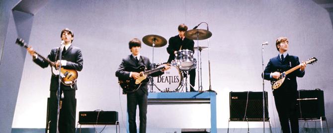 The Beatles (from left to right), Paul McCartney (bass), George Harrison (guitar), Ringo Starr (drums) and John Lennon (guitar) perform on stage during a concert in London on July 29, 1965