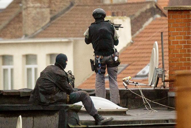 Special force officers stand on a rooftop in Rue Delaunoy, Molenbeek. Pic/AFP
