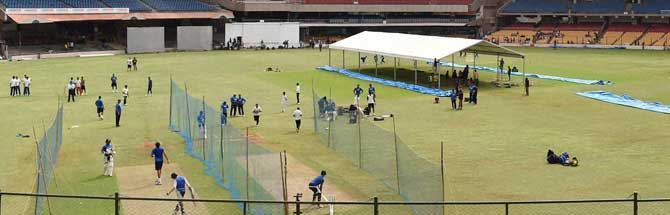 Indian and South African cricketers during a practice session ahead of the 2nd test match at Chinnaswamy Stadium in Bengaluru on Thursday. The canopy protects the 22-yard