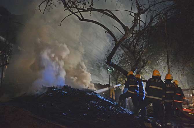 Firemen trying to douse the blaze that broke out at a Kandivali catering shop on Thursday. 