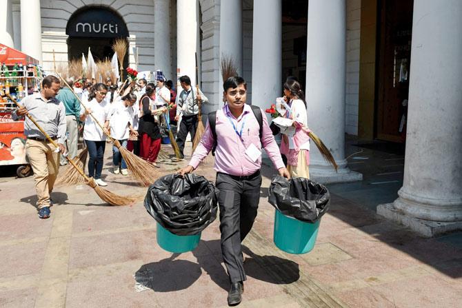 School children and social activists cleaning a footpath during a campaign launched under the Swachh Bharat Abhiyan in New Delhi on October 1. Union Urban Development Minister M Venkaiah Naidu said they have done better than our own internal targets on sanitation, hygiene and building toilets to curb open defecation. Pic/AFP
