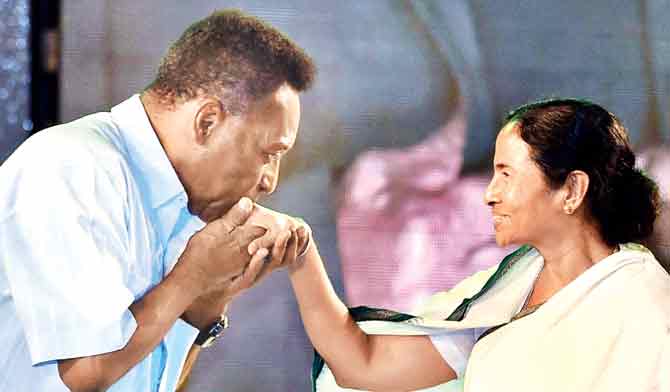 Pele greets West Bengal Chief Minister Mamata Banerjee in Kolkata yesterday evening. Pic/PTI