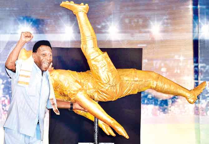 Pele reacts after unveiling a sculpture of his famous bicycle kick during an interaction with students in Kolkata yesterday evening. Pics/PTI