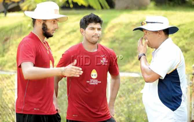 Mumbai coach Chandrakant Pandit (right) with Harmeet Singh (left) and Akhil Herwadkar during a practice session at the Bandra Kurla Complex ground yesterday