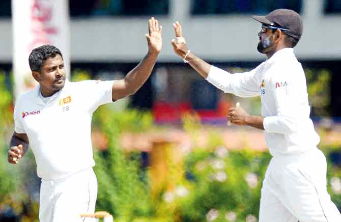  Sri Lankan spinner Rangana Herath (left) celebrates West Indies Devendra Bishoo