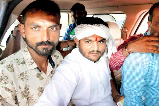 Hardik Patel (in white) who was arrested on the Rajkot-Jamnagar Highway near Rajkot yesterday. Pic/PTI