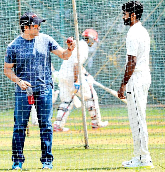 Sachin Tendulkar gives tips to Mumbai spinner Vishal Dabholkar at BKC ground on Monday. Pic/PTI