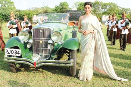 Deepika Padukone poses with a vintage car at an event in Jaipur