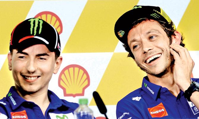 Valentino Rossi (right) and teammate Jorge Lorenzo share a light moment during a press conference yesterday. Pic/AFP
