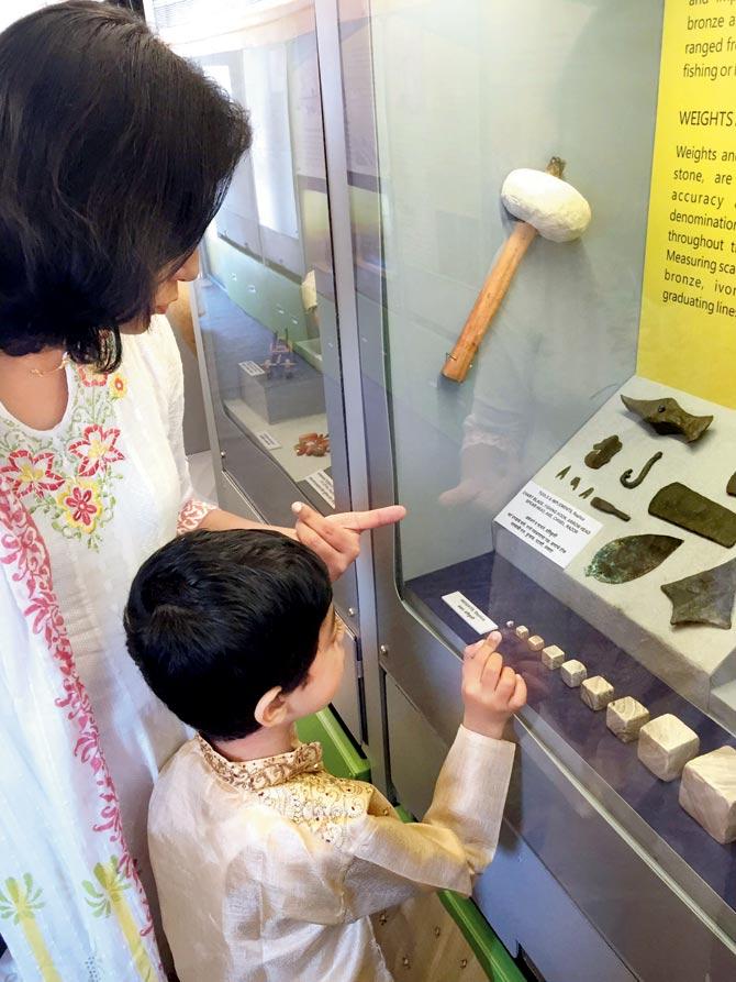 WHAT’S THAT, MA? A child checks out pieces of weights used from the Indus Valley Civilisation inside the Museum on Wheels