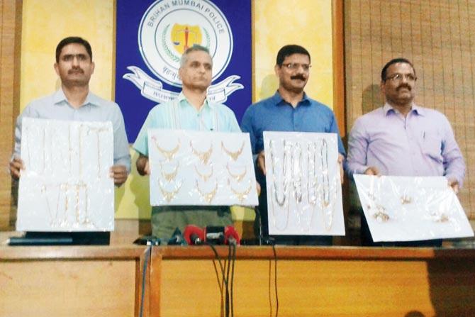 Crime Branch officers with the recovered gold jewellery