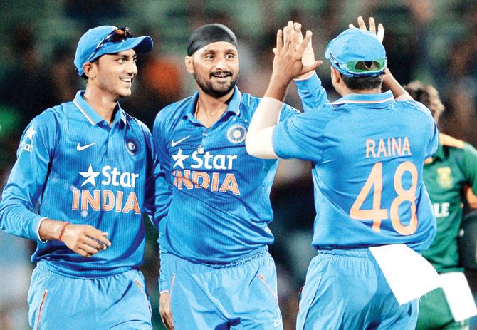Harbhajan Singh (centre) celebrates a South African wicket with teammates Suresh Raina and Axar Patel in Chennai on Thursday. Pic/AFP