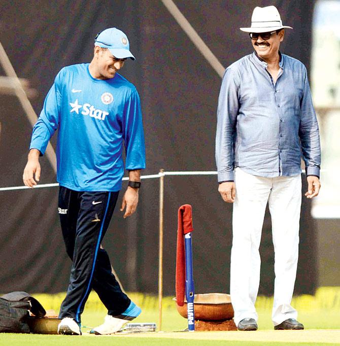 MS Dhoni (left) shares a light moment with Dilip Vengsarkar during a practice session at the Wankhede Stadium on Saturday