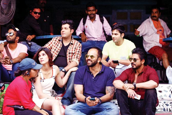 Rohit with Shah Rukh Khan and (below) with his cast and crew