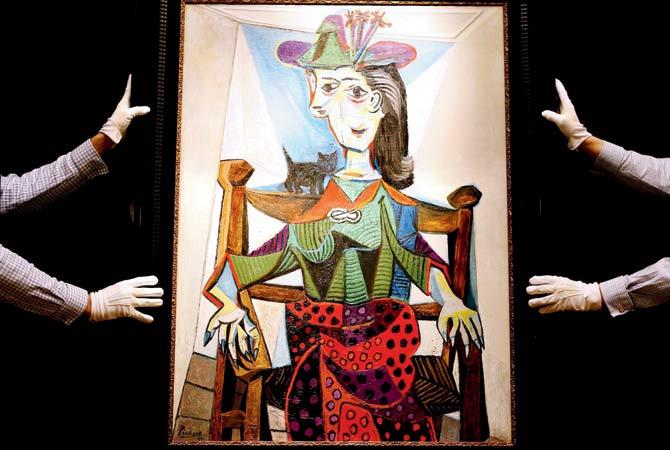 Pablo Picasso’s portrait of Dora Maar, his mistress and principal source of inspiration, being prepared to go under the hammer at Sothebys auction house in London in 2006. Pic/Afp