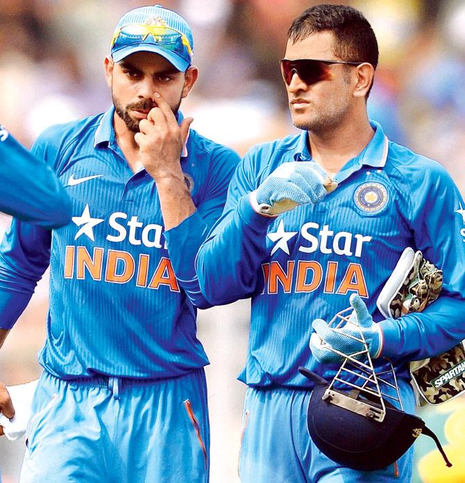 India skipper Mahendra Singh Dhoni (right) speaks with Virat Kohli during the fifth ODI against South Africa at Wankhede Stadium yesterday. Pic/AFP