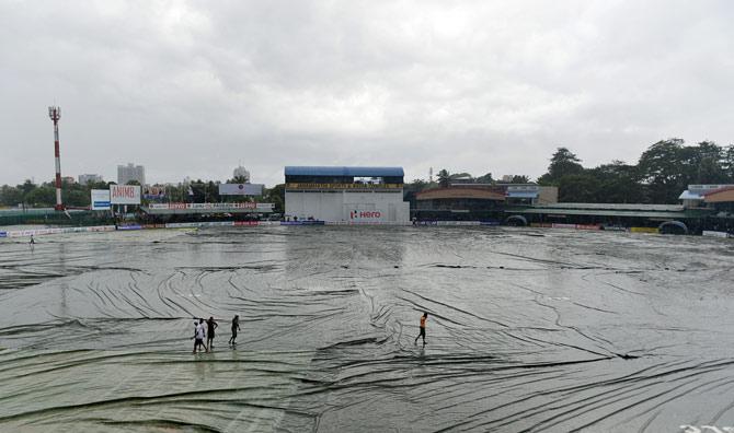 Sri Lankan ground staff walk on the covers as rain stops play during the third day of the second Test match between Sri Lanka and the West Indies at the P. Sara Oval Cricket Stadium in Colombo. Pic/AFP
