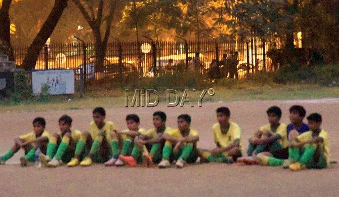 St Stanislaus (Bandra) players wait for play to resume after the U-14 Division I final was stopped due to bad light. Pic/Suresh KK