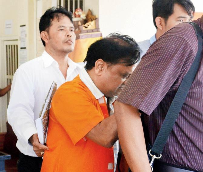 Chhota Rajan being escorted by plain-clothed police officers to the local police hospital for a health examination in Denpasar, Bali, Indonesia, yesterday. Pic/PTI