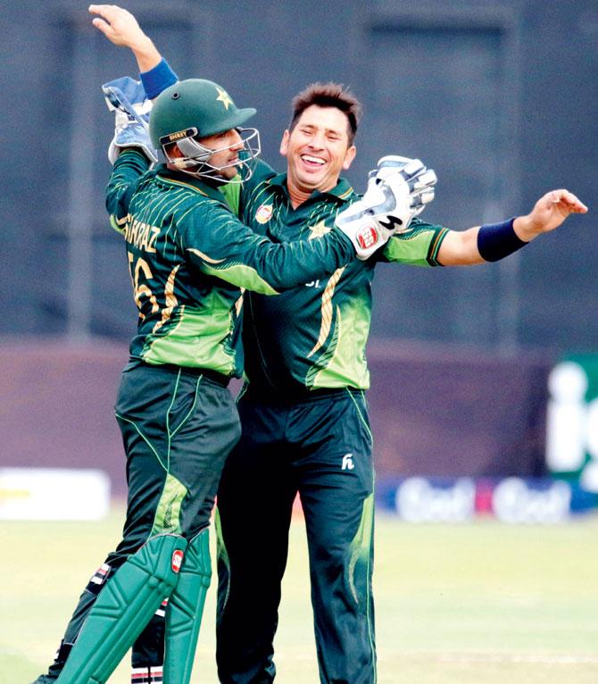 Yasir Shah celebrates a Zimbabwe wicket with ’keeper Sarfraz Ahmed in Harare yesterday. Pic/AFP