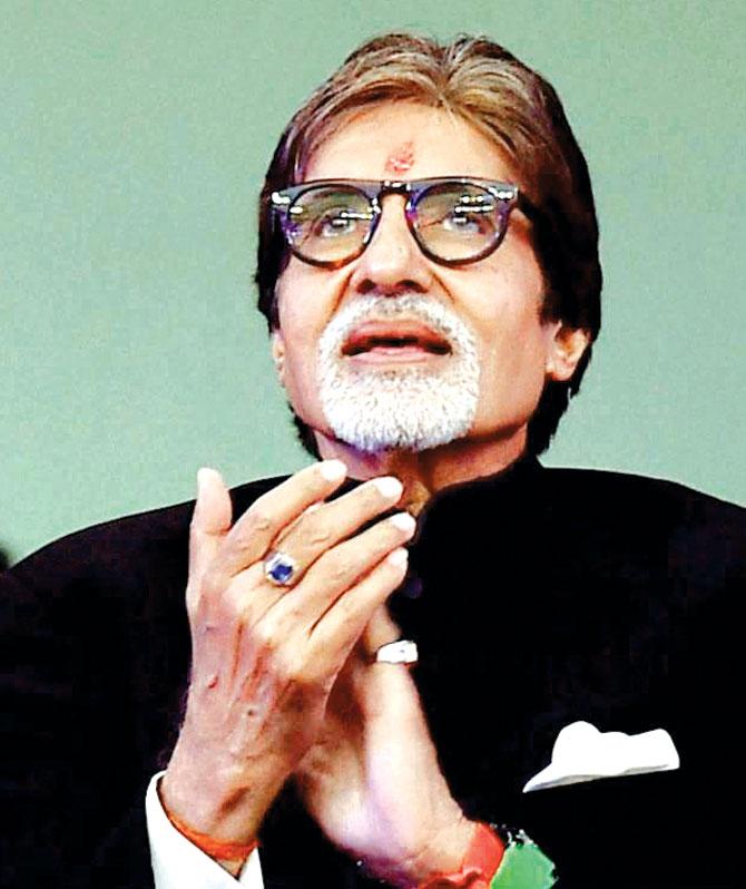Amitabh Bachchan applauds as the ISL opening ceremony gets to a fever pitch level. Pic/PTI