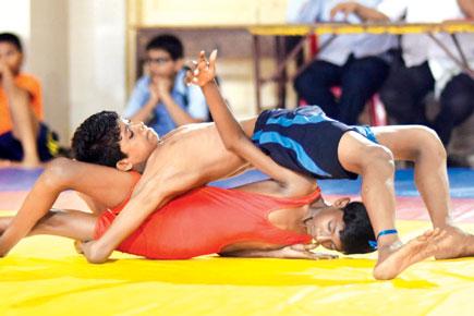 Azam Shah (in blue) grapples with Vishal Sharma during the DSO boys U-17 42 kg Freestyle bout in Lower Parel yesterday