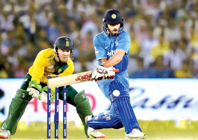 Shikhar Dhawan reverse sweeps a South African spinner during the second T20I at Barabati Stadium. Pic/PTI