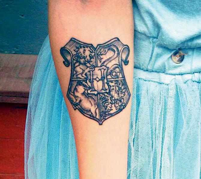 Avani has a Hogwarts School coat of arms tattoo 